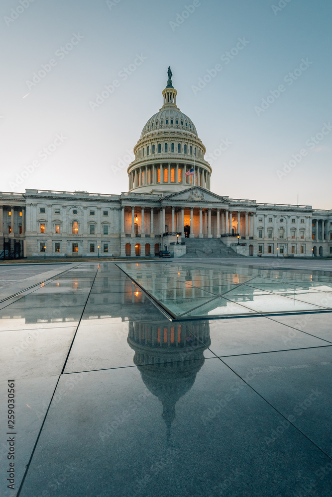 Fototapeta premium The United States Capitol reflecting in glass, in Washington, DC