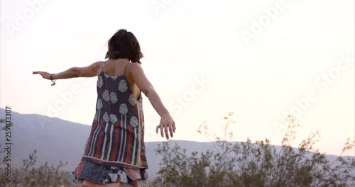 Stylish young free spirited woman walking in desert - care free adeventure photo