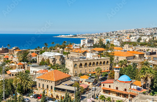 Mediterranean city historic center panorama with old church and mosque and residential buildings in the background, Biblos, Lebanon photo