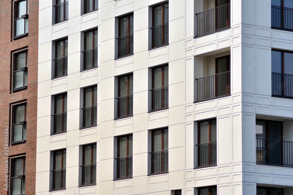 Fragment of a modern apartment building in front. Very modern apartment house. Fragment of a modern apartment building in front. Very modern apartment house.