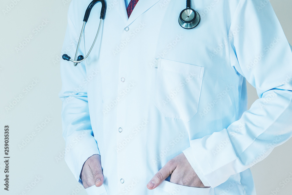 Bright close up of male doctor with stethoscope, Medical concept, hands in pocket Bright close up of male doctor with stethoscope, Medical concept, hands in pocket