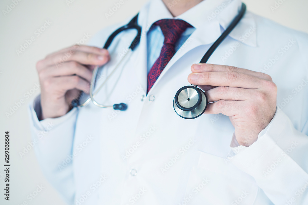 Bright close up of male doctor with stethoscope. Medical concept Bright close up of male doctor with stethoscope. Medical concept
