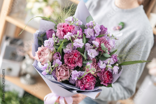 Wallpaper Mural beautiful fresh cut bouquet of mixed flowers in woman hand. the work of the florist at a flower shop. Spring mood Torontodigital.ca