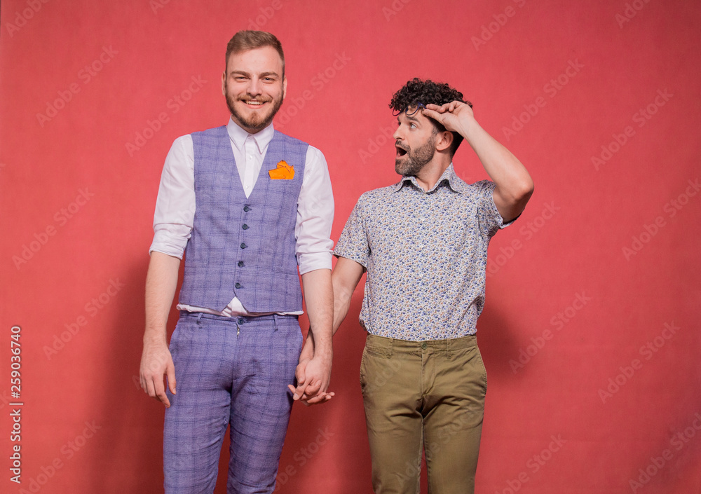 one young silly feminine man looking at his partner, in awe and shock.