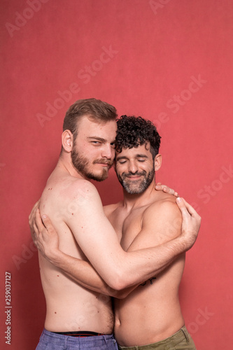 sexy gay couple, hugging each other. eyes closed, and looking to camera, calm. © HD92