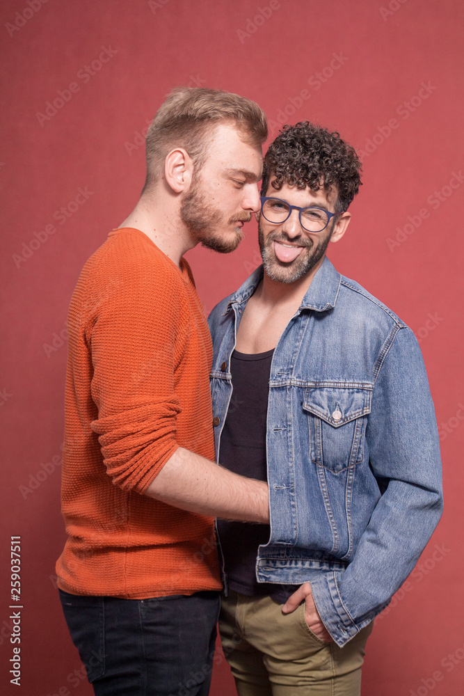 gay couple together, posing in front of camera.