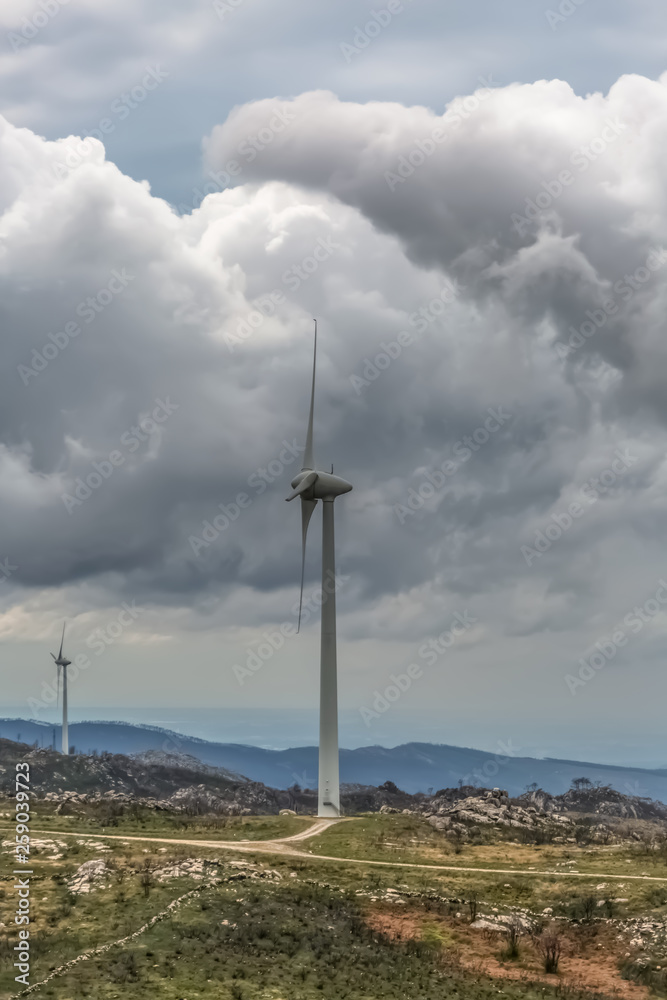 View of a wind turbines on top of mountains