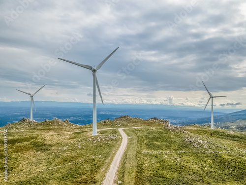 Detailed aerial view  by drone  of a wind turbines on top of mountains
