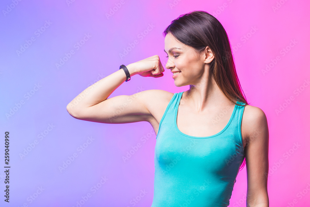Portrait of athletic young woman showing biceps muscles isolated against white background. Fitness concept, healthy life. Portrait of athletic young woman showing biceps muscles isolated against white background. Fitness concept, healthy life.