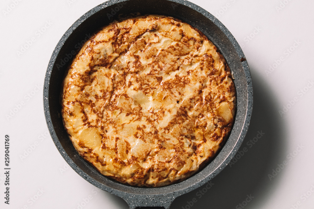 tortilla de patatas on white background, typical spanish dish tortilla de patatas on white background, typical spanish dish