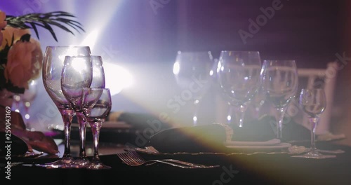 Cutlery on table with a black tablecloth in rays of light from the music scene. The festive dinner in luxury restaurant