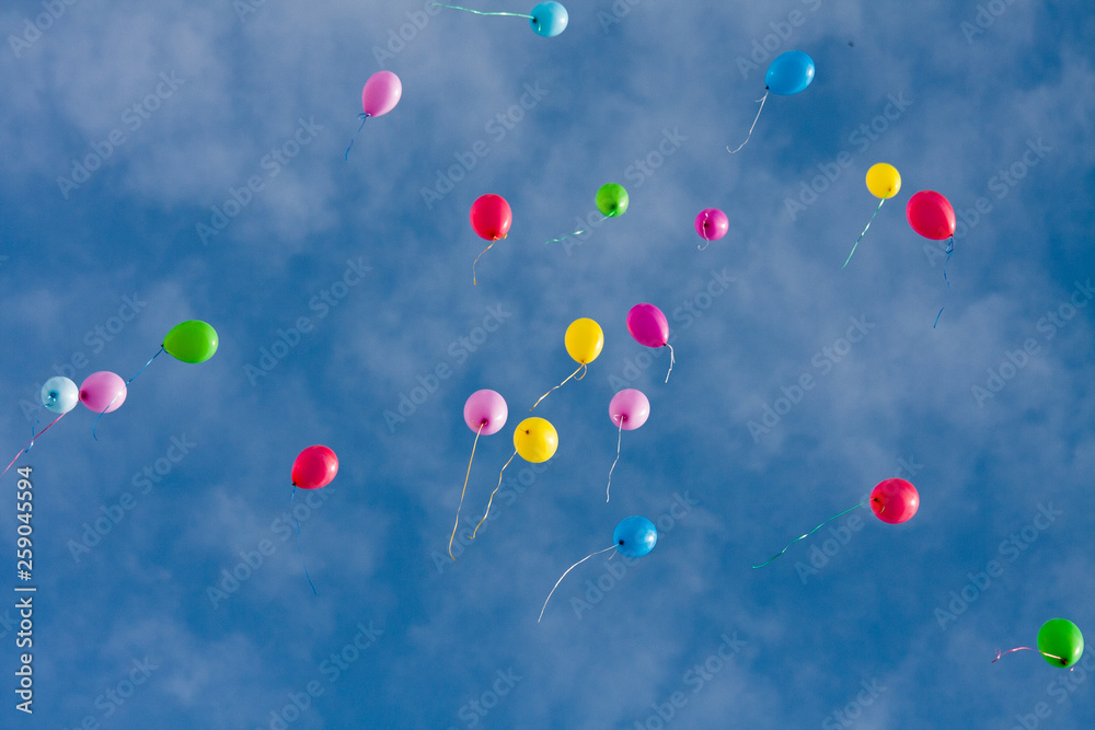 Colorful toy balloons floating in the blue sky. Colorful toy balloons floating in the blue sky.