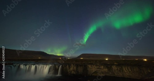 Timelapse of amazing northern lights over waterfall in Iceland