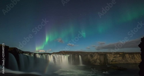 Timelapse of amazing northern lights over waterfall in Iceland