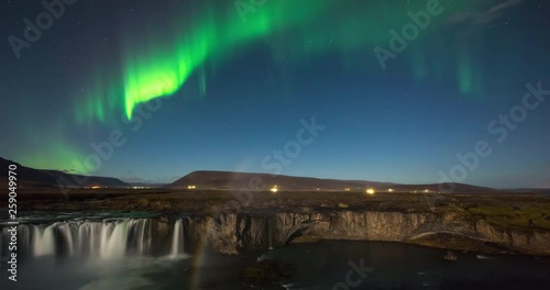Timelapse of amazing northern lights over waterfall in Iceland