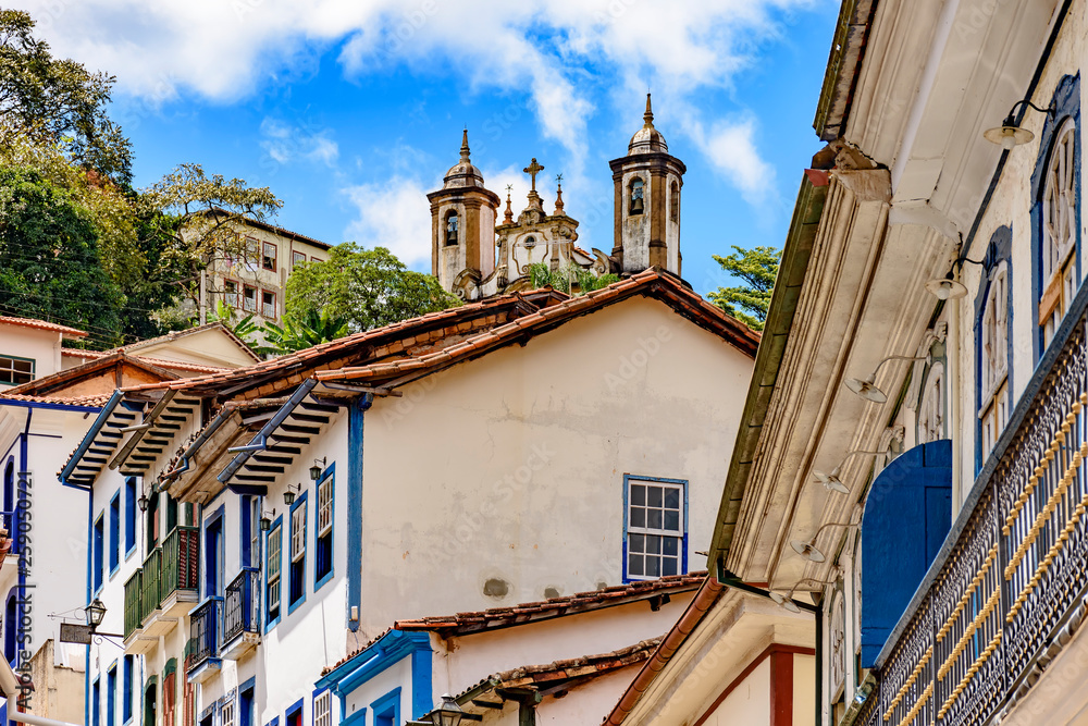 Colonial houses of the center of the historic Ouro Preto city in Minas Gerais, Brazil with its famous churches and old buildings in background