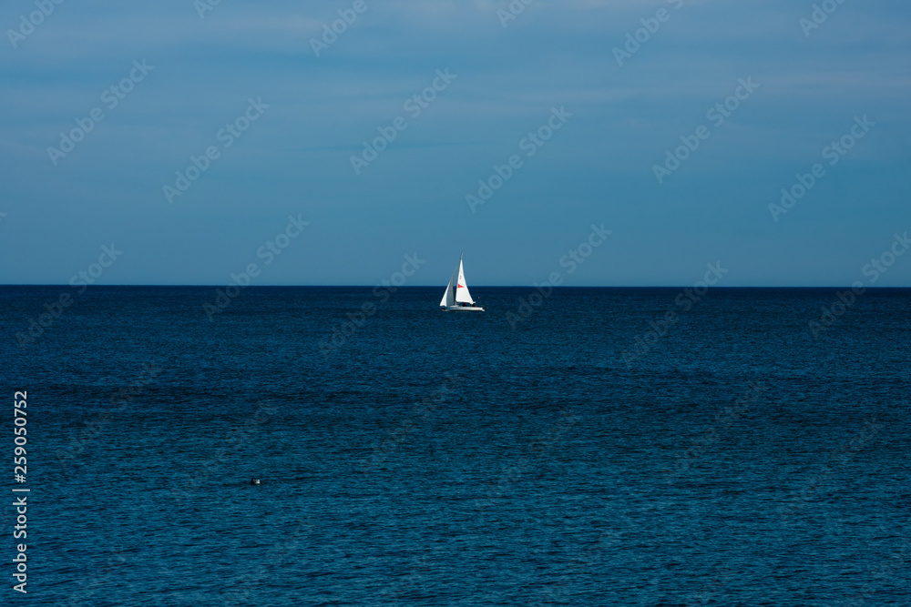 View of a sailboat in the Mediterranean sea. Barcelona, Spain