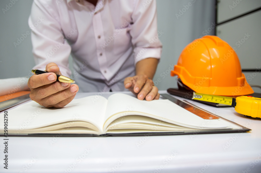 Engineer and Architect planing and discuss at Construction Site with blueprint.concept Engineer and Architect planing and discuss at Construction Site with blueprint.concept