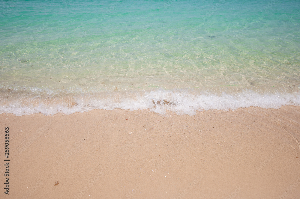 Blue ocean soft sea wave on clear sandy beach