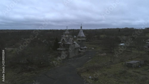View of the old Church of St. Dmitry, November evening (aerial video). Sheleiki village, Leningrad region. Russia  photo