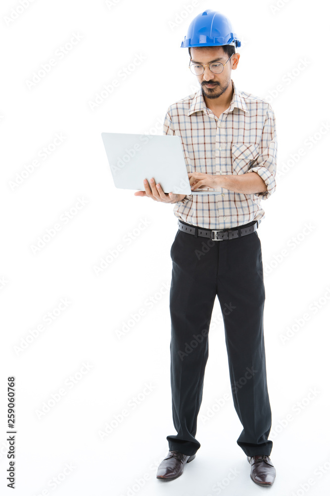 Engineer man blue helmet typing notebook Engineer man blue helmet typing notebook