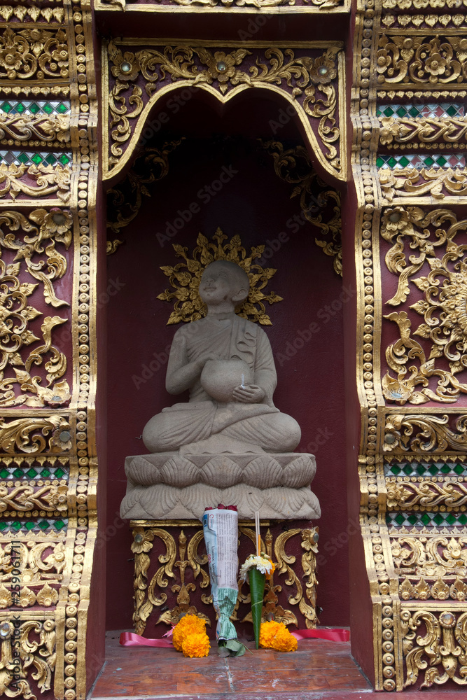 Chiang Mai Thailand, temple niche Buddha statue and offerings at Wat Saen Muang Ma Luang