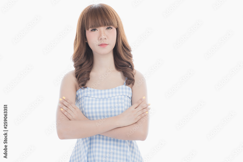 Front view close-up portrait of young beautiful Asian woman with curly long dark brown hair in light blue checked dress stand up straight isolated white background Front view close-up portrait of young beautiful Asian woman with curly long dark brown hair in light blue checked dress stand up straight isolated white background