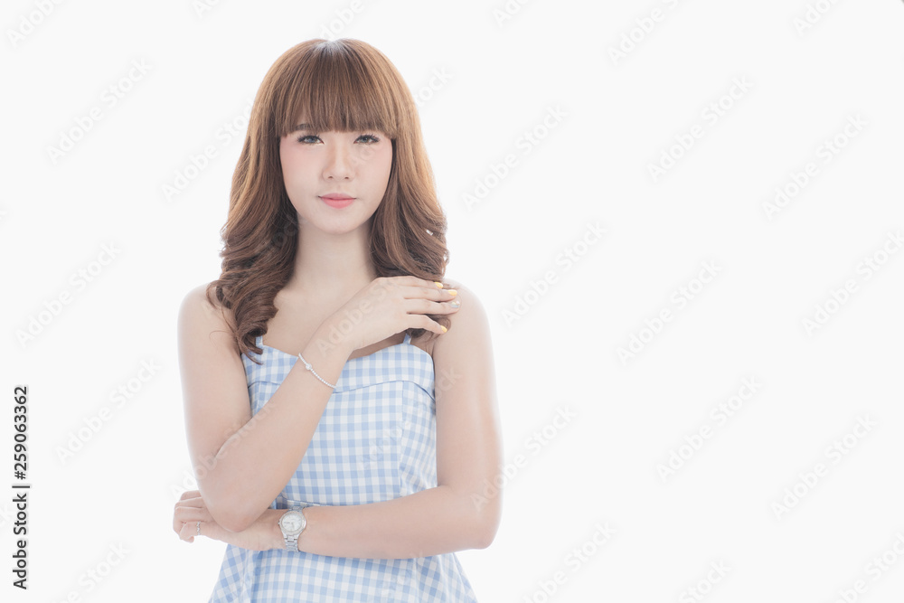 Front view close-up portrait of young beautiful Asian woman with curly long dark brown hair in light blue checked dress stand up straight isolated white background Front view close-up portrait of young beautiful Asian woman with curly long dark brown hair in light blue checked dress stand up straight isolated white background