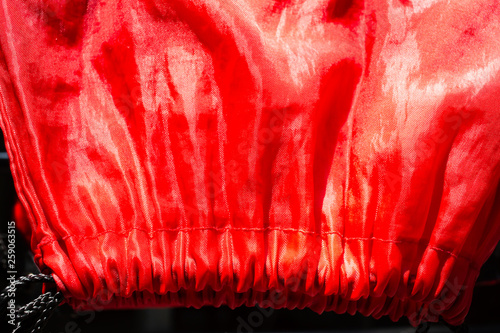 Fotografie Dry Polyester Tote Bag in the sun, Red glossy texture backgroud, Close up & macr