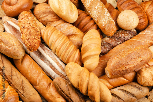 Assortment of baked bread on table background.