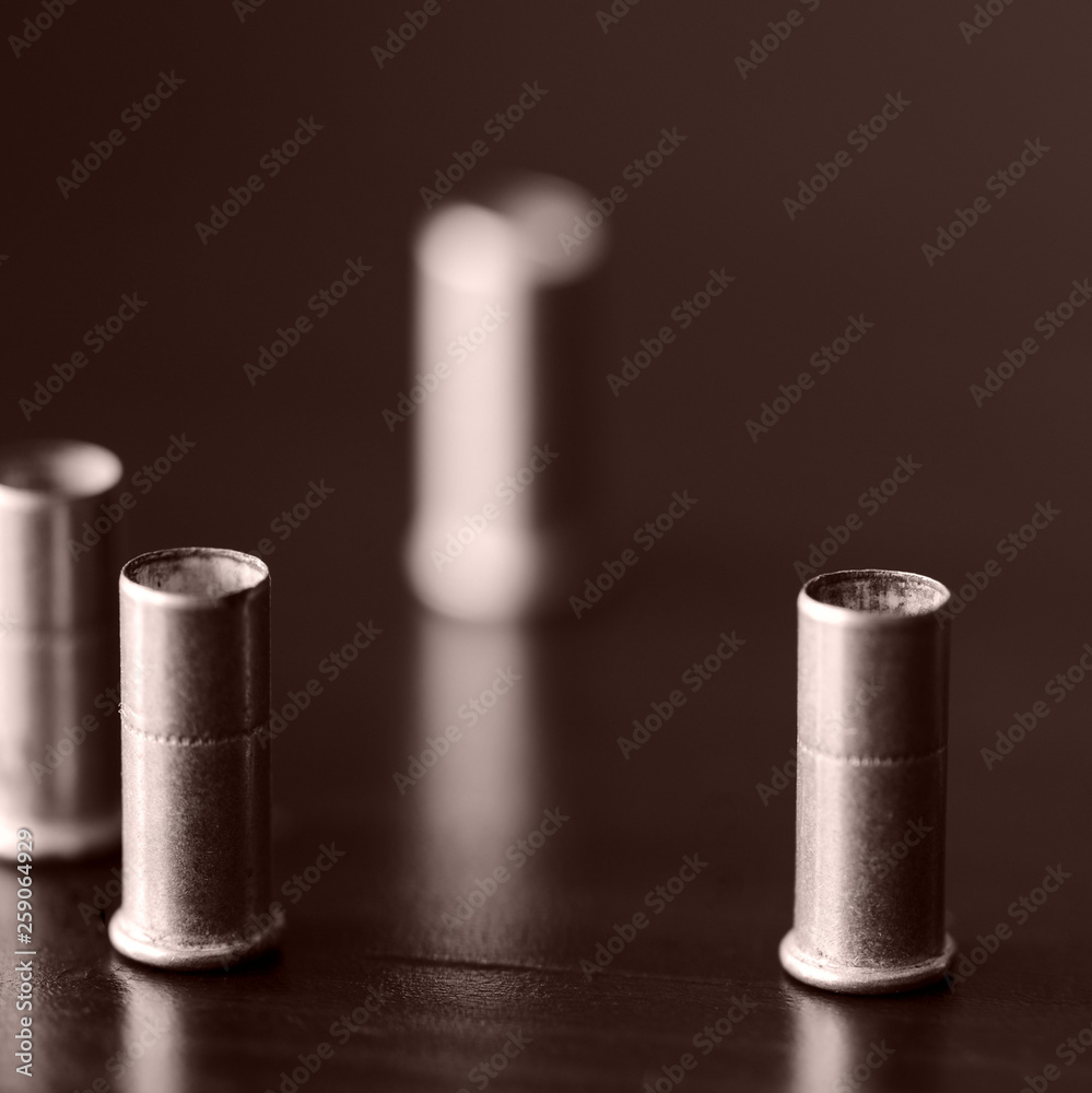 Old bullet cartridges on a dark background close up. Brown color toned