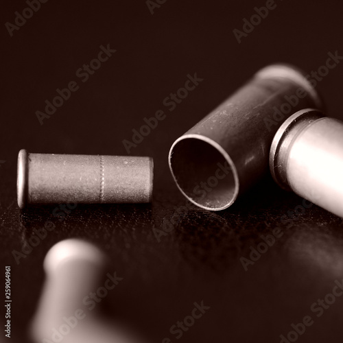 Old bullet cartridges on a dark background close up. Brown color toned