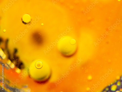 Yellow spheres on abstract orange background. Close up macro shot. Blurred background. Selective soft focus. Pattern of abstract orange universe. Scores of yellow bubbles