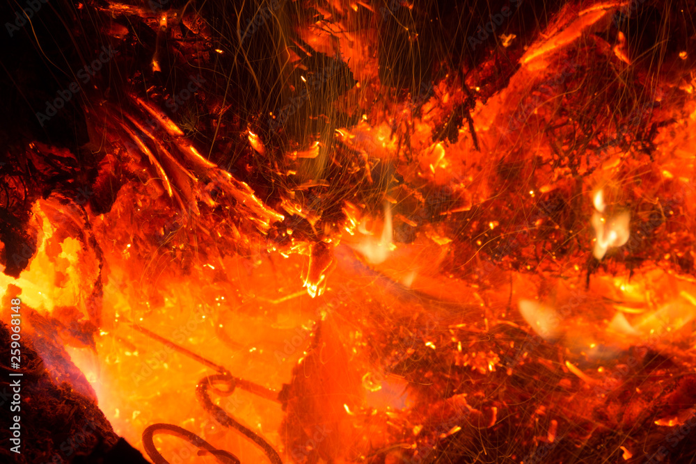 Bright sparkling coals with fire as background