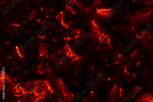 Bright sparkling coals with fire as background