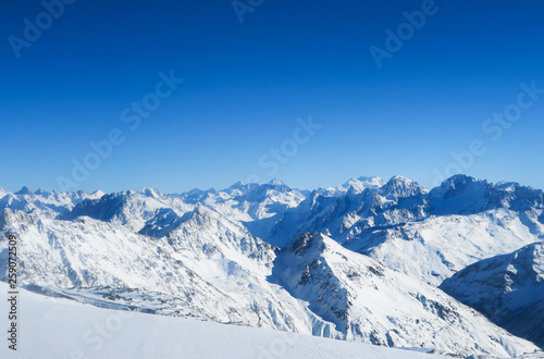 Mountain range of Caucasian Mountains in the blue sky. Elbrus region © Olga