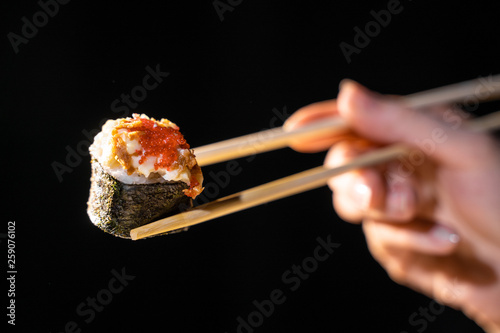 Maki sushi served on black background