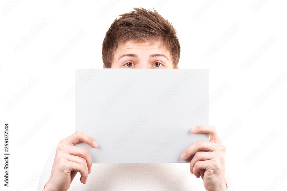 A young man covers his face with a blank sheet of paper. Isolation on white background A young man covers his face with a blank sheet of paper. Isolation on white background