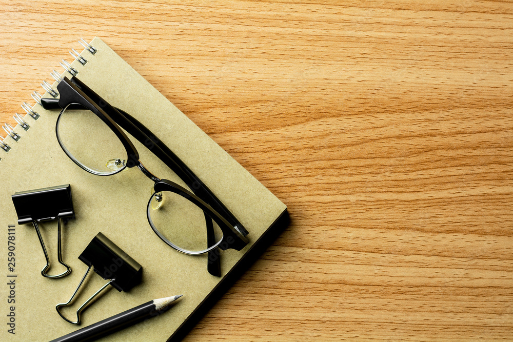 book, pencil and a glasses on wooden desk. - for creative and business concept background. book, pencil and a glasses on wooden desk. - for creative and business concept background.