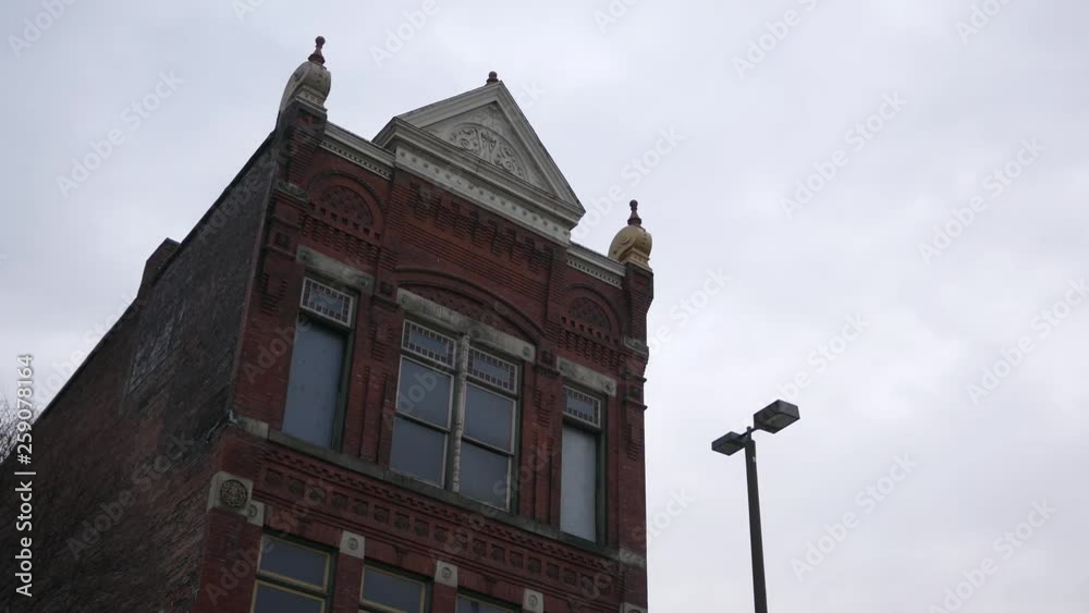 Establishing shot of old fashioned red brick building on overcast evening Establishing shot of old fashioned red brick building on overcast evening