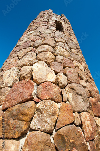 Quadro em tela Tower made of rocks with a small window at the top