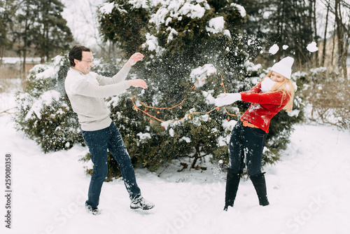 Happy Couple Having Fun Outdoors in Snow Park. Winter Vacation