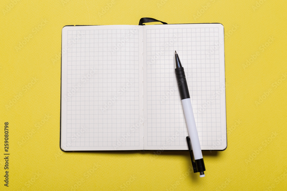school notebook on a yellow background school notebook on a yellow background