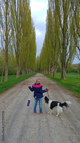 girl with dog at parkway in nature
