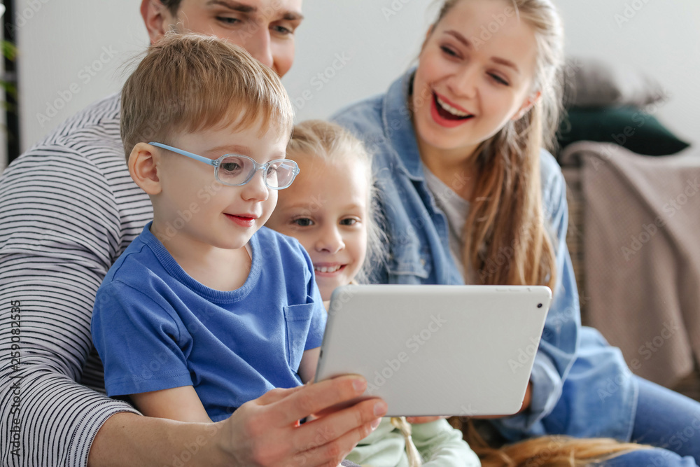 Happy family watching cartoons at home
