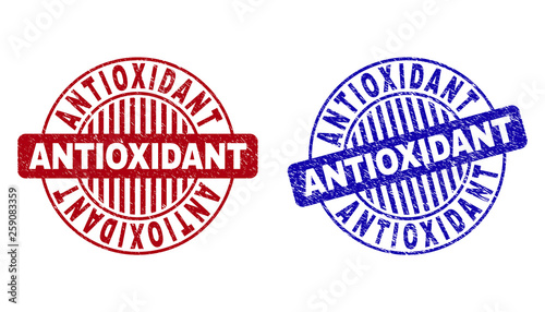 Grunge ANTIOXIDANT round stamp seals isolated on a white background. Round seals with distress texture in red and blue colors.