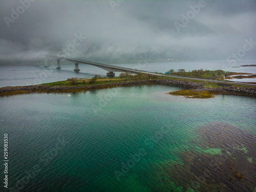 Aerial view. Bridge over fjord on Lofoten islands. Summer time, foggy hazy day, overcast weather.
