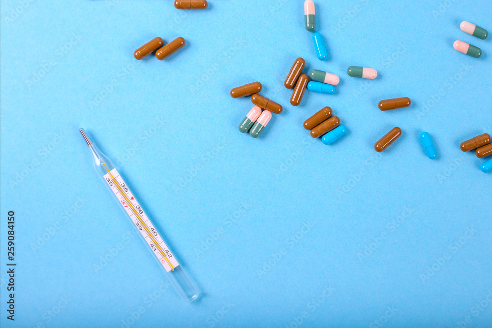 Flat lay of medicine pills and thermometer Flat lay of medicine pills and thermometer
