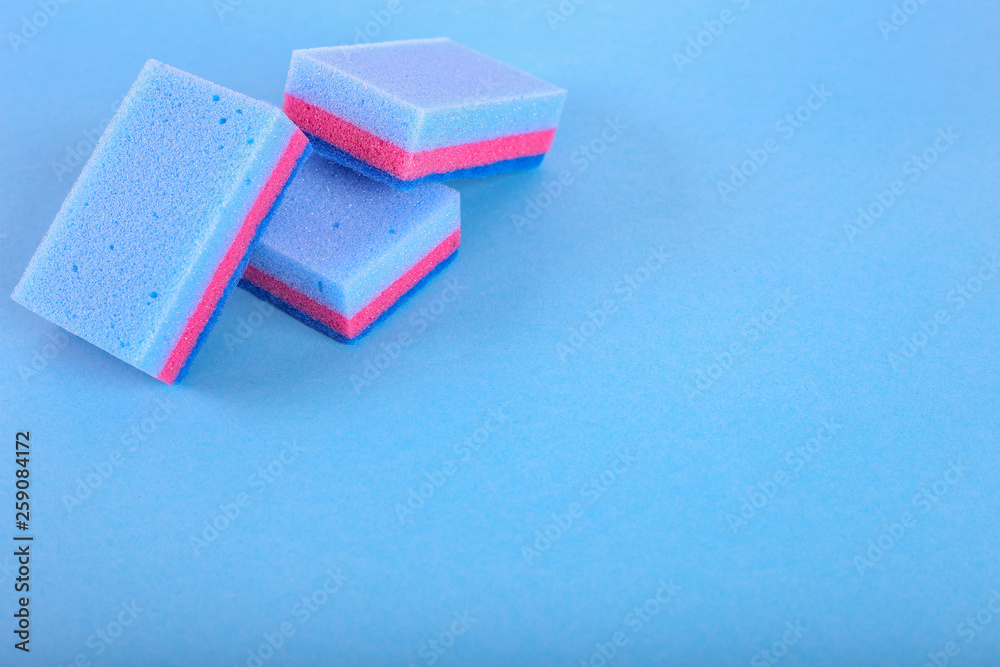 Cleaning sponges on a blue background. With copy space for text. Cleaning sponges on a blue background. With copy space for text.