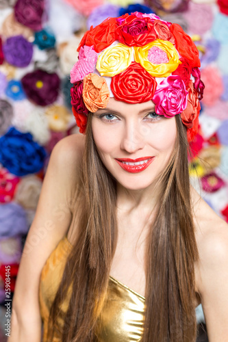 Elegant woman in a hat over floral background 